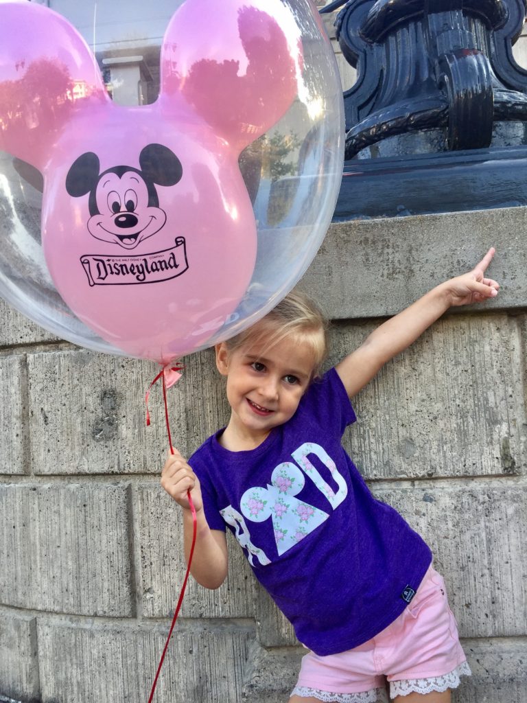 little girl with pink disneyland balloon disneyland tips and tricks 
