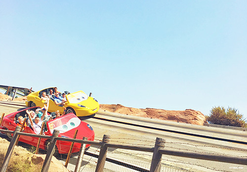 Two cars racing at Radiator Springs in Disneyland Disneyland With Kids - 102 Tips You Need To Know